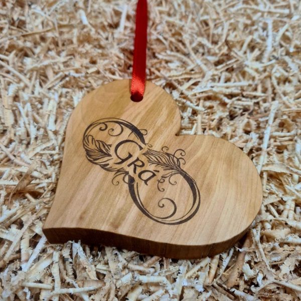 Wooden love heart decoration engraved with Gaelic word for "Love" - "Grá". With red ribbon attached.